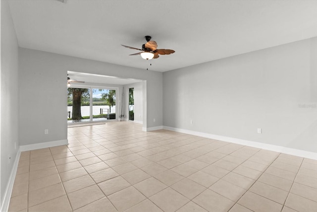 11446 W Bayshore Dr Unit 36, Crystal River, FL 34429 - empty room with a ceiling fan, light tile patterned floors, and a water view