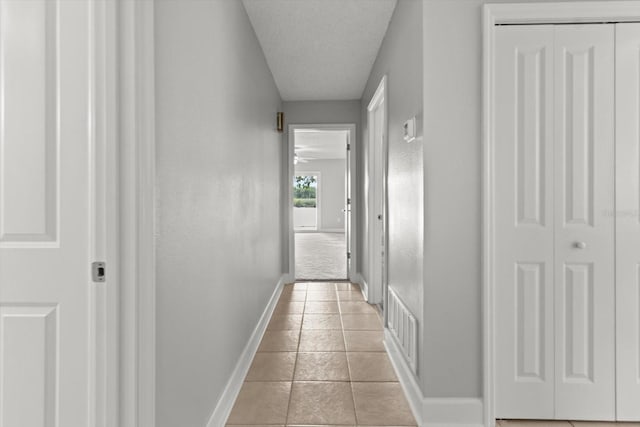 11446 W Bayshore Dr Unit 36, Crystal River, FL 34429 - corridor featuring light tile patterned flooring and a textured ceiling