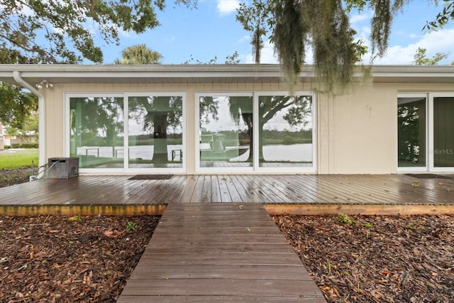 11446 W Bayshore Dr Unit 36, Crystal River, FL 34429 - back of house featuring a wooden deck and stucco siding