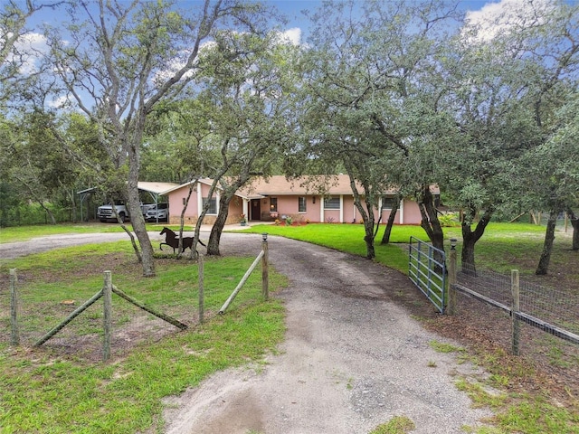 18531 Ozark Dr, Hudson, FL 34667 - view of front facade featuring curved driveway and stucco siding