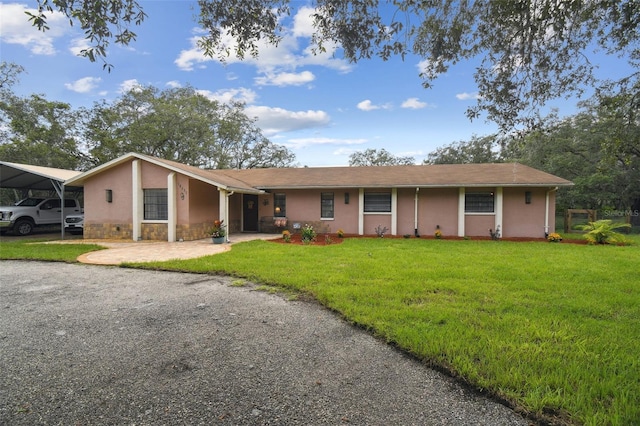18531 Ozark Dr, Hudson, FL 34667 - single story home with stone siding, a front lawn, and stucco siding
