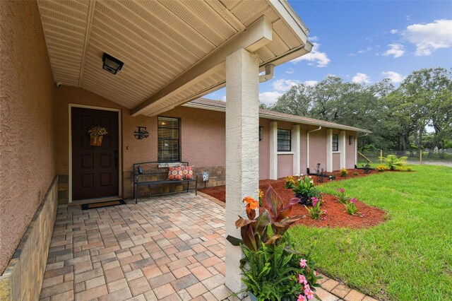 18531 Ozark Dr, Hudson, FL 34667 - property entrance featuring stucco siding and a porch