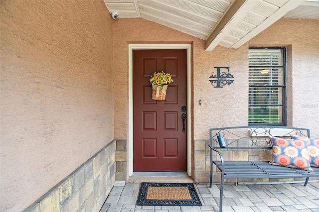 18531 Ozark Dr, Hudson, FL 34667 - property entrance featuring stucco siding and a security system