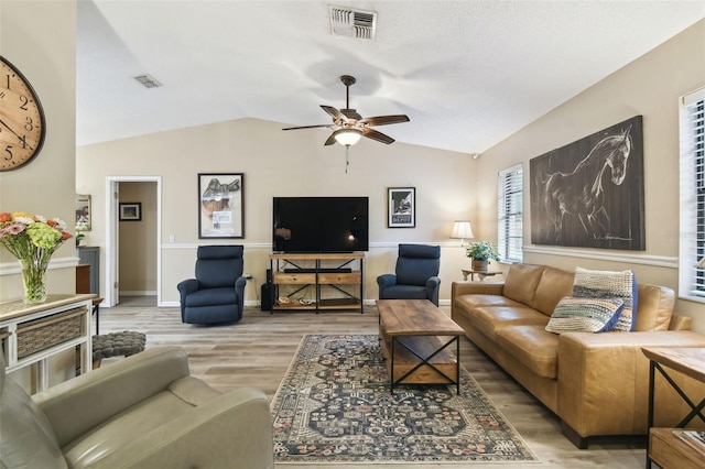 18531 Ozark Dr, Hudson, FL 34667 - living area with vaulted ceiling, a ceiling fan, and wood finished floors