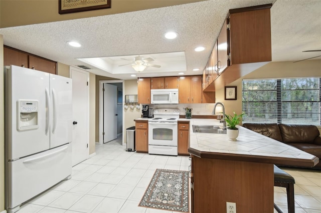 18531 Ozark Dr, Hudson, FL 34667 - kitchen featuring white appliances, ceiling fan, tile countertops, a textured ceiling, and brown cabinetry