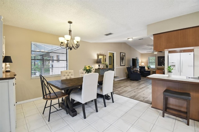 18531 Ozark Dr, Hudson, FL 34667 - dining space with a chandelier, lofted ceiling, ceiling fan, and a textured ceiling