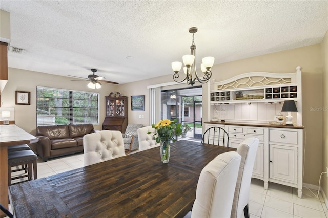 18531 Ozark Dr, Hudson, FL 34667 - dining space featuring light tile patterned floors, a chandelier, plenty of natural light, and a textured ceiling