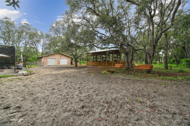 18531 Ozark Dr, Hudson, FL 34667 - view of yard featuring an outbuilding and a detached garage
