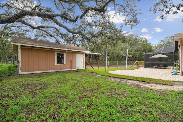 18531 Ozark Dr, Hudson, FL 34667 - view of yard featuring a patio, a lanai, and an outbuilding