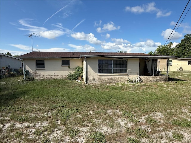 12813 Vassar Ct, Hudson, FL 34667 - back of house with concrete block siding and a yard