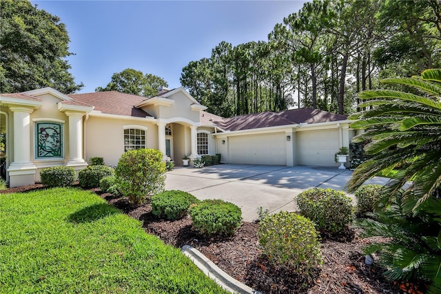 5301 Legend Hills Ln, Spring Hill, FL 34609 - view of front of property featuring stucco siding, an attached garage, and concrete driveway