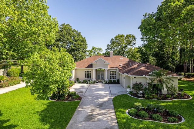5301 Legend Hills Ln, Spring Hill, FL 34609 - mediterranean / spanish home featuring french doors, stucco siding, a front lawn, and roof with shingles