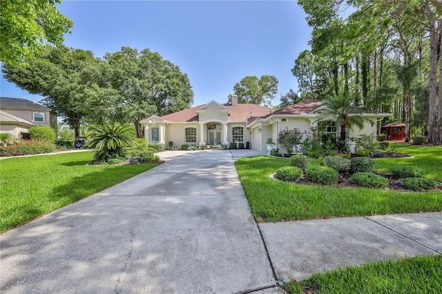 5301 Legend Hills Ln, Spring Hill, FL 34609 - view of front of property featuring concrete driveway, an attached garage, a front lawn, and stucco siding