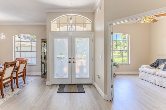 5301 Legend Hills Ln, Spring Hill, FL 34609 - foyer entrance featuring french doors, light wood-type flooring, healthy amount of natural light, and crown molding