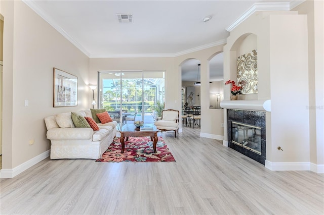 5301 Legend Hills Ln, Spring Hill, FL 34609 - living room featuring wood finished floors, crown molding, a tile fireplace, and a sunroom
