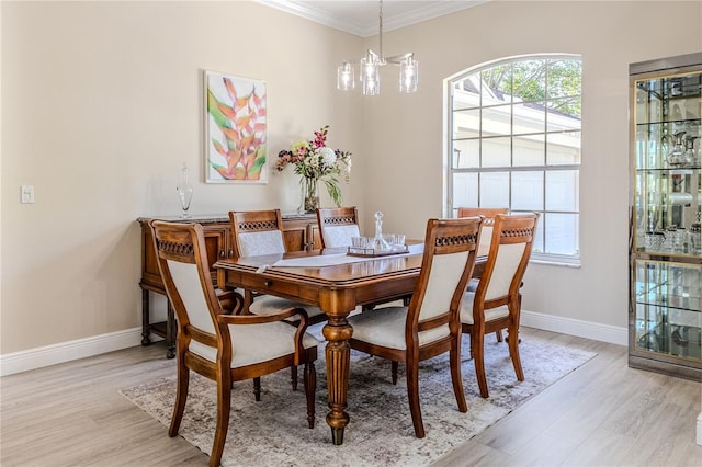 5301 Legend Hills Ln, Spring Hill, FL 34609 - dining space featuring light wood-type flooring, ornamental molding, and a chandelier