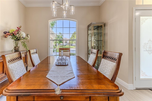 5301 Legend Hills Ln, Spring Hill, FL 34609 - dining space featuring crown molding, wood finished floors, and a chandelier