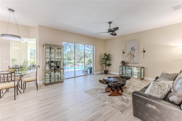 5301 Legend Hills Ln, Spring Hill, FL 34609 - living area with a ceiling fan and light wood-style floors