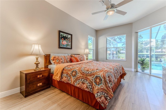 5301 Legend Hills Ln, Spring Hill, FL 34609 - bedroom featuring access to exterior, multiple windows, light wood-style flooring, and a ceiling fan