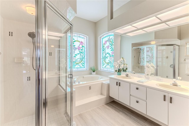 5301 Legend Hills Ln, Spring Hill, FL 34609 - full bath featuring a shower stall, a garden tub, double vanity, and wood finished floors