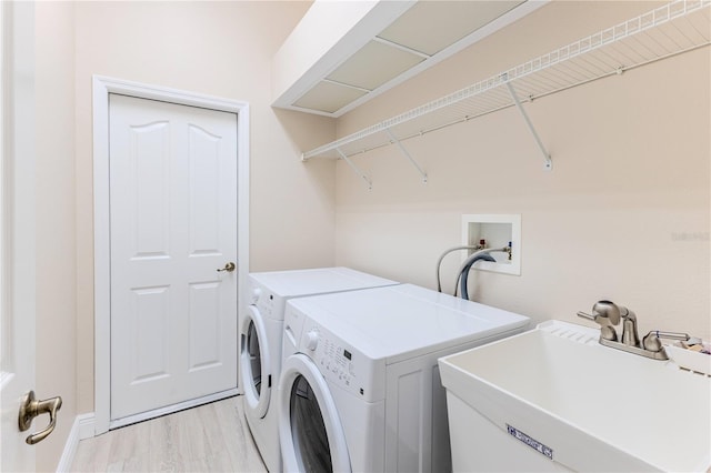 5301 Legend Hills Ln, Spring Hill, FL 34609 - laundry room featuring separate washer and dryer and light wood-type flooring