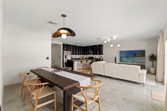 12948 Conquistador Loop, Spring Hill, FL 34610 - dining area featuring light tile patterned floors and baseboards