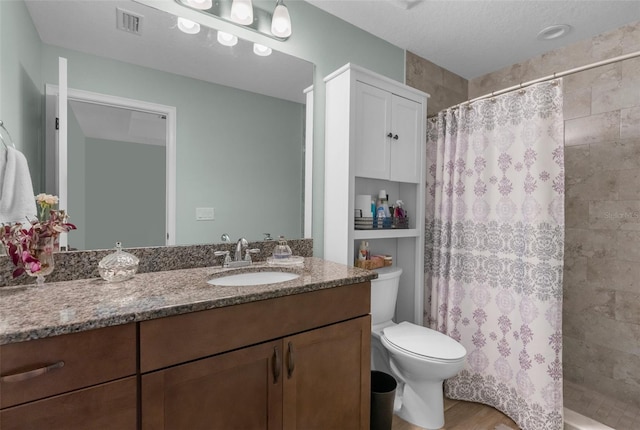 9863 Deer St, Spring Hill, FL 34608 - bathroom featuring vanity, a tile shower, and wood finished floors