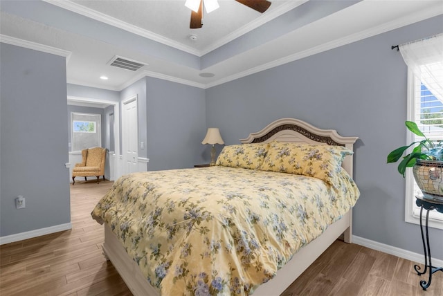 9863 Deer St, Spring Hill, FL 34608 - bedroom with multiple windows, wood finished floors, a ceiling fan, a closet, and crown molding