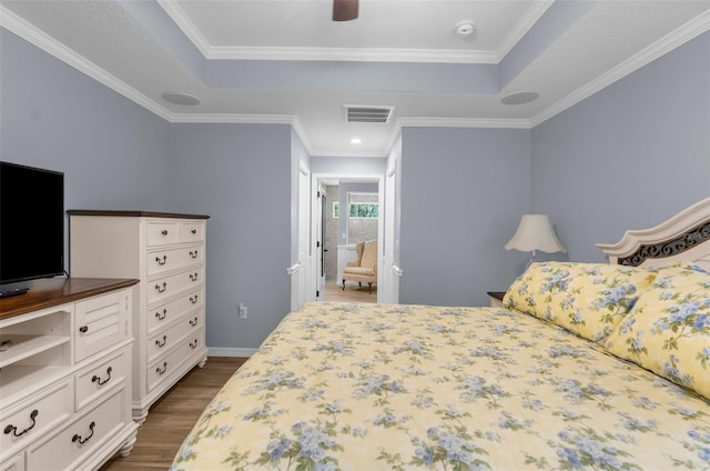 9863 Deer St, Spring Hill, FL 34608 - bedroom featuring a tray ceiling, dark wood-type flooring, ornamental molding, and a ceiling fan