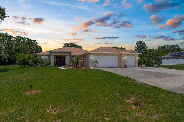 9863 Deer St, Spring Hill, FL 34608 - view of front facade with an attached garage, driveway, and stucco siding