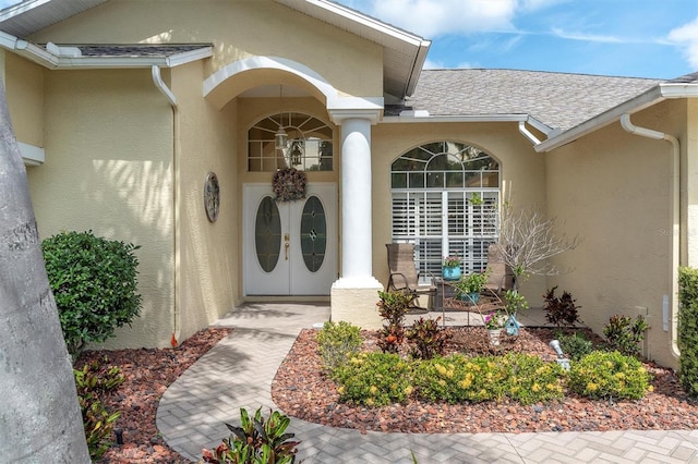 1610 Winding Willow Dr, Trinity, FL 34655 - view of exterior entry with stucco siding and roof with shingles