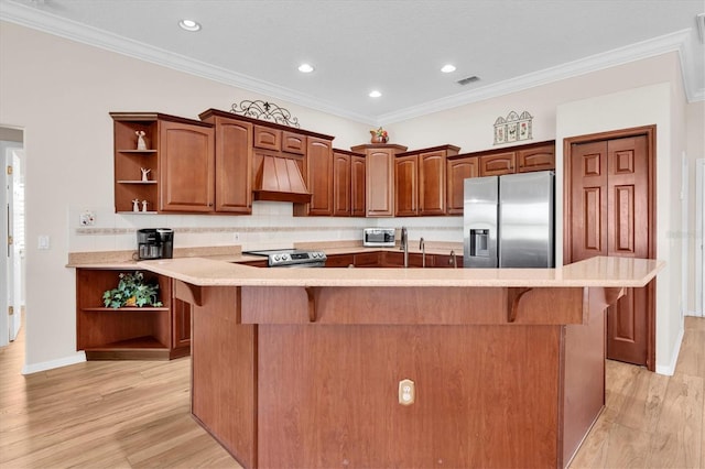 1610 Winding Willow Dr, Trinity, FL 34655 - kitchen with open shelves, appliances with stainless steel finishes, premium range hood, a kitchen bar, and light wood finished floors