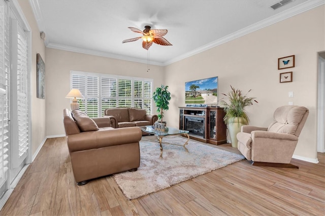 1610 Winding Willow Dr, Trinity, FL 34655 - living area featuring a ceiling fan, wood finished floors, and crown molding