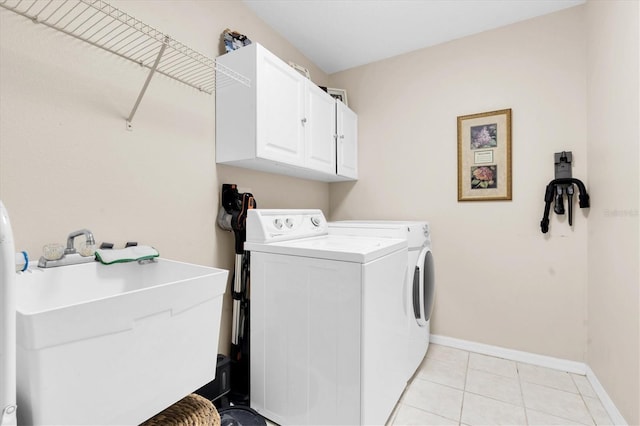 1610 Winding Willow Dr, Trinity, FL 34655 - washroom featuring cabinet space, separate washer and dryer, and light tile patterned floors