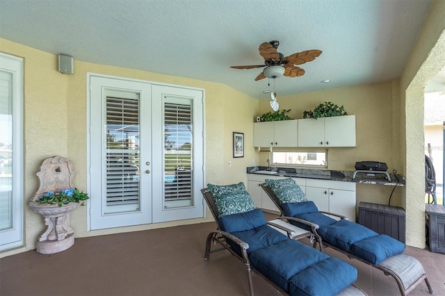 1610 Winding Willow Dr, Trinity, FL 34655 - carpeted living room featuring french doors, a ceiling fan, and a textured ceiling