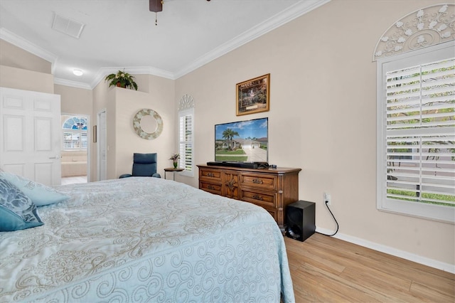 1610 Winding Willow Dr, Trinity, FL 34655 - bedroom featuring multiple windows, wood finished floors, crown molding, connected bathroom, and a ceiling fan