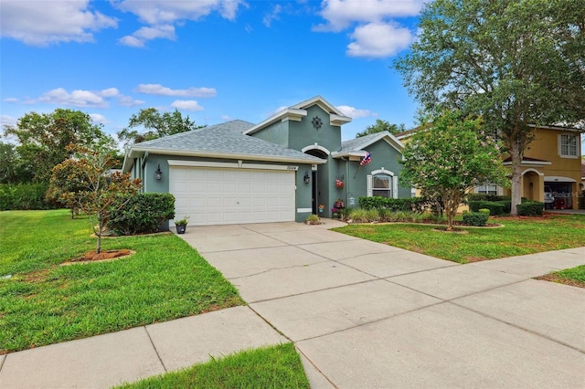 15604 Durango Cir, Brooksville, FL 34604 - view of front of property with an attached garage, stucco siding, concrete driveway, a front lawn, and roof with shingles