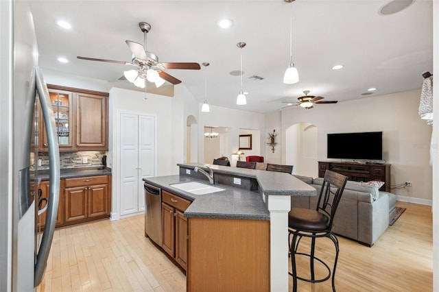 15604 Durango Cir, Brooksville, FL 34604 - kitchen featuring arched walkways, stainless steel appliances, ceiling fan, dark countertops, and recessed lighting
