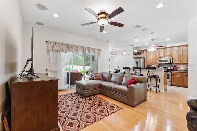 15604 Durango Cir, Brooksville, FL 34604 - living area featuring a ceiling fan, light wood-type flooring, and recessed lighting