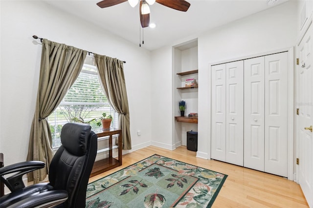 15604 Durango Cir, Brooksville, FL 34604 - office area with a ceiling fan, light wood-style floors, and built in shelves
