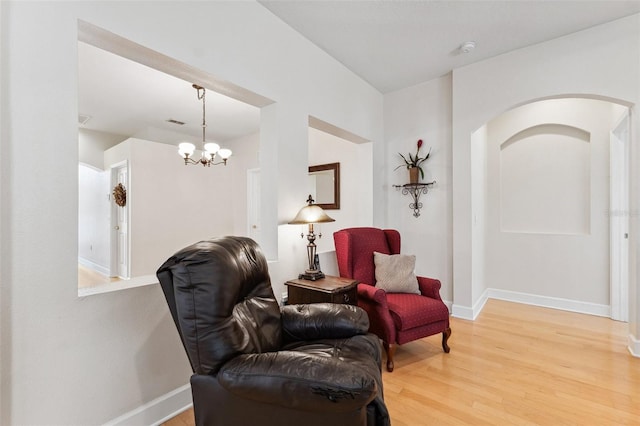 15604 Durango Cir, Brooksville, FL 34604 - sitting room with light wood-style flooring, a chandelier, and arched walkways