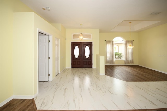 8311 Coral Creek Loop, Hudson, FL 34667 - entrance foyer with a chandelier and marble look tiles