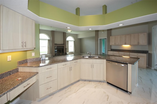 8311 Coral Creek Loop, Hudson, FL 34667 - kitchen with stainless steel dishwasher, light marble finish flooring, dark stone countertops, a towering ceiling, and recessed lighting