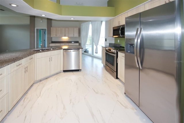8311 Coral Creek Loop, Hudson, FL 34667 - kitchen featuring stainless steel appliances, a towering ceiling, dark stone countertops, light marble finish floors, and recessed lighting