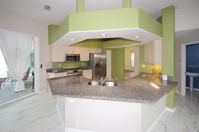 8311 Coral Creek Loop, Hudson, FL 34667 - kitchen with stainless steel appliances, a peninsula, light marble finish flooring, stone counters, and light brown cabinets