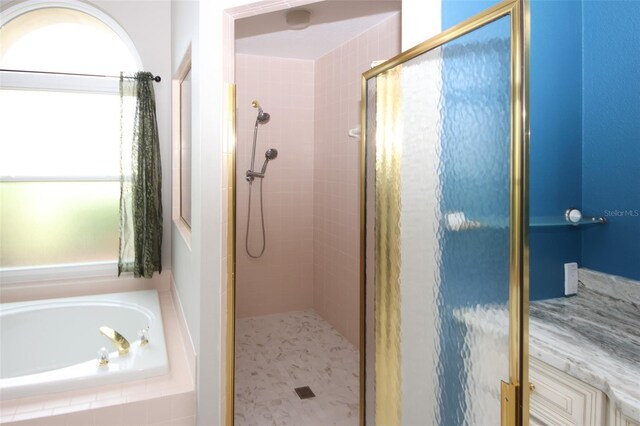8311 Coral Creek Loop, Hudson, FL 34667 - bathroom with a stall shower and a garden tub
