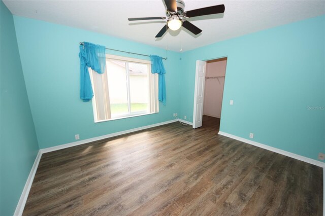 8311 Coral Creek Loop, Hudson, FL 34667 - unfurnished bedroom with wood finished floors, a closet, a ceiling fan, and a spacious closet