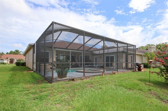 8311 Coral Creek Loop, Hudson, FL 34667 - rear view of house featuring an outdoor pool, a yard, a patio area, and stucco siding