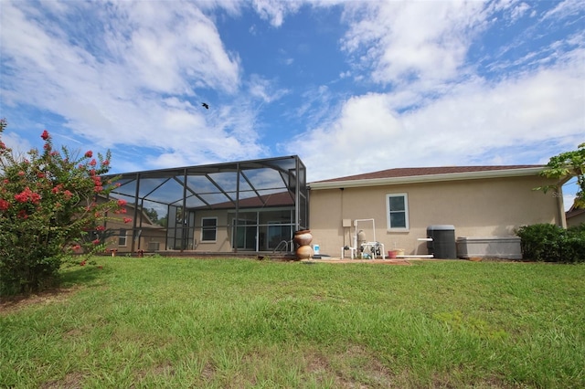 8311 Coral Creek Loop, Hudson, FL 34667 - back of house featuring stucco siding, a yard, and glass enclosure