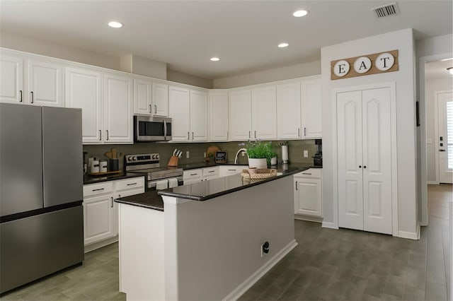 14647 Potterton Cir, Hudson, FL 34667 - kitchen featuring appliances with stainless steel finishes, white cabinets, decorative backsplash, and recessed lighting